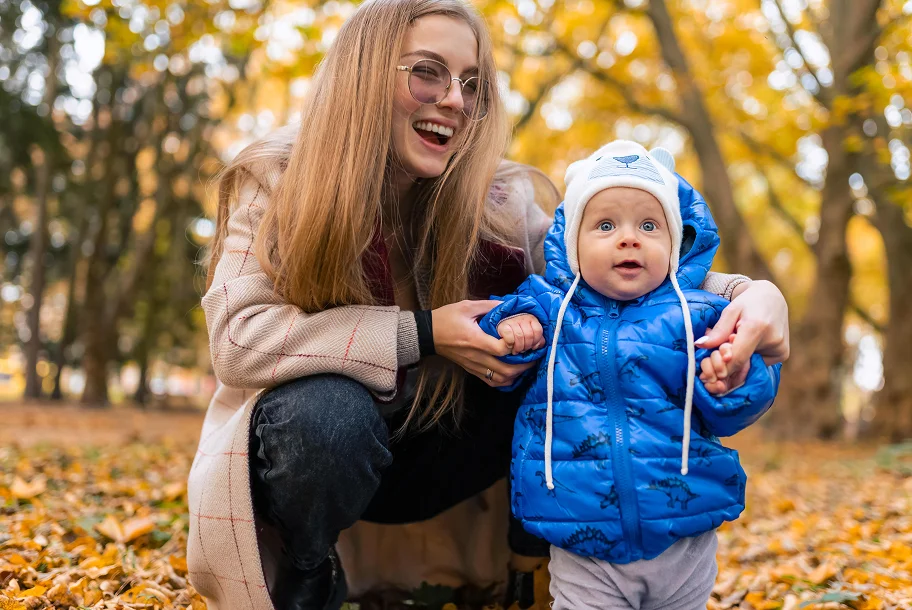 mom teaches the kid to walk young mother walks in